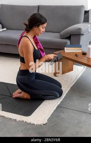 Woman resting after practicing an online yoga session at home Stock Photo