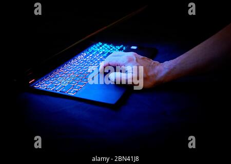 hands on a laptop, backlit keyboard Stock Photo