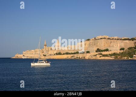 Valletta, Malta, a historic European fortified city. Landscape view from Marsamxett during golden hour. Travel and tourism in the Mediterranean Sea. Stock Photo