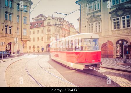 Typical old retro vintage tram on tracks near tram stop in the streets of Prague city in Lesser Town Mala Strana district, Bohemia, Czech Republic. Public transport concept. Stock Photo