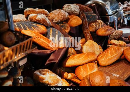 many rolls of different breads in the bakery restaurant Stock Photo