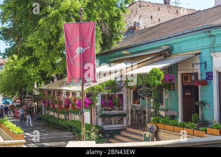 BELGRADE, SERBIA - 8TH MAY 2018: A view along Skadarlija (street) in Belgrade, a popular spot for trying traditional Serbian food at the many restaura Stock Photo