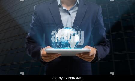 International business and technologies. Businessman holding tablet computer with Earth hologram, collage Stock Photo