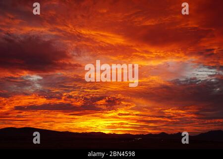 The fiery and intense colors of a mid summer Northern Arizona sunset. Stock Photo