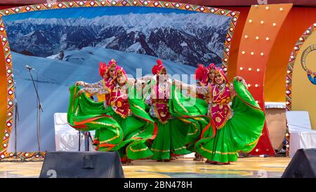 Young Indian Male and Female dancers performing regional/folk dance in colorful dresses Stock Photo