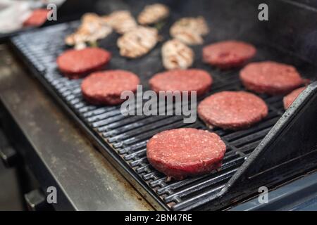 Ground beef cutlets being cooked on a grill pan Stock Photo