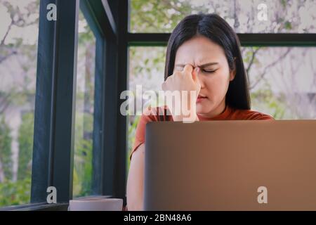 stressed businesswoman headache working on laptop computer. Negative human emotion facial expression feelings Stock Photo