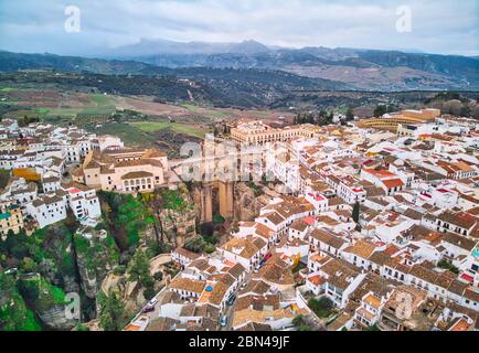 Aerial photography Ronda cityscape, residential houses buildings exterior rooftop, New bridge stunning canyons. Costa del Sol, Malaga, Spain Stock Photo
