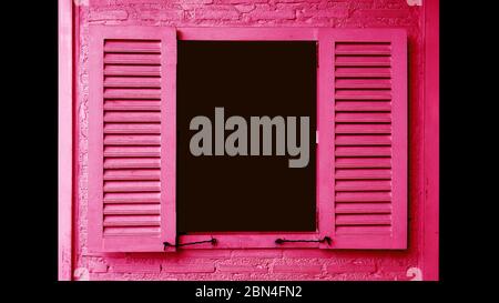 Vivid pink colored wooden window with opening shutters on brick wall Stock Photo