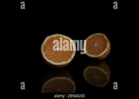 two halves of juicy lemon on a black background Stock Photo