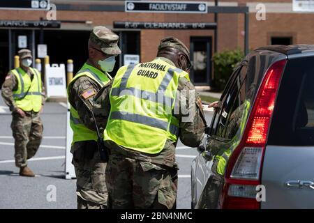 Kennesaw, GA, USA. 12th May, 2020. Soldiers from Georgia National Guard direct local residents to free COVID-19 testing in a parking deck at Kennesaw State University. Credit: Robin Rayne/ZUMA Wire/Alamy Live News Stock Photo