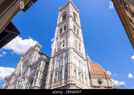 Florence, Italy - August 16, 2019: Cathedral Santa Maria Del Fiore and Giotto's Campanile on Piazza del Duomo in Florence