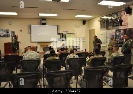 National Guard soldiers receive a briefing from station commanders on their first day at Falfurrias Station. Stock Photo