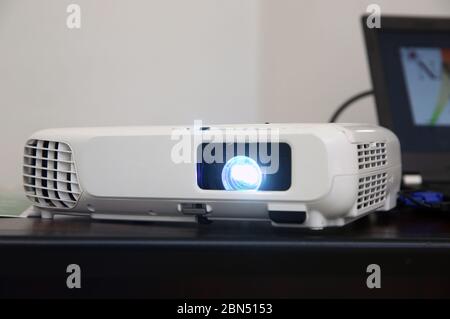LCD video projector at business conference or lecture in office with copy space. projector on ceiling indoors. LCD video projector at business Stock Photo