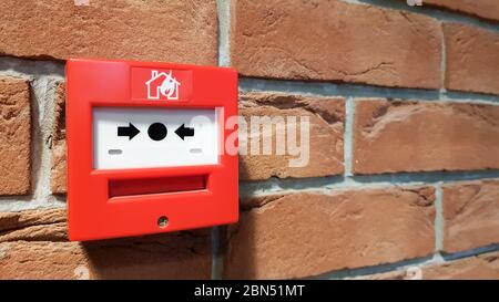 fire alarm system box installed on wall in building Stock Photo