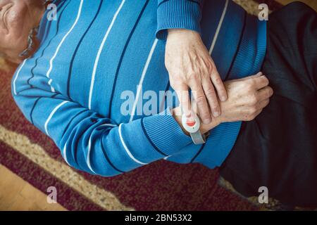 Senior man fallen pressing red button on emergency call device Stock Photo