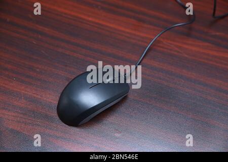Mouse Red furniture on the table . A black computer mouse . Stock Photo