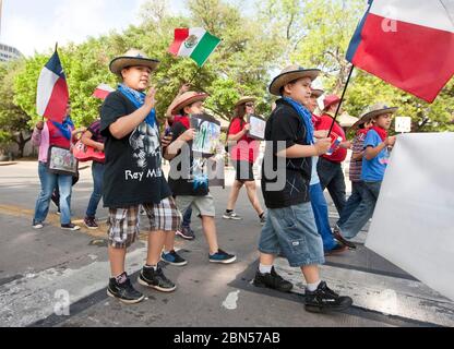 Austin Texas USA, March 2012: Children holding Texas and Mexican flags march in a parade on Congress Avenue celebrating the unveiling of the Tejano Monument on the grounds of the Texas Capitol. The monument honors contributions of Tejanos, the Spanish speaking settlers who brought cowboy culture from Mexico into the area that became Texas. ©Marjorie Kamys Cotera/Daemmrich Photography Stock Photo