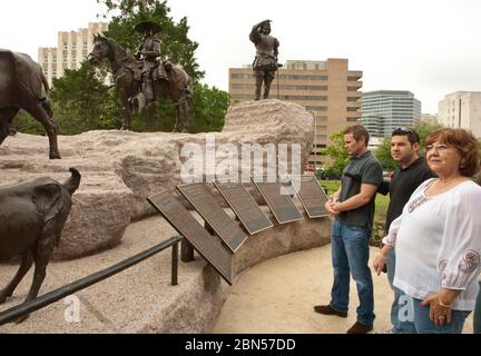 Austin Texas USA, March 2012: Visitors view the newly unveiled Tejano Monument on the Texas Capitol grounds. The granite and bronze monument by Laredo artist Armando Hinojosa weighs 250 tons and is a tribune to early Spanish and Mexican explorers and settlers in the area that became Texas. ©Marjorie Kamys Cotera/Daemmrich Photography Stock Photo
