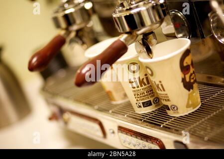 Two espresso cups getting filled in a portafilter machine Stock Photo -  Alamy