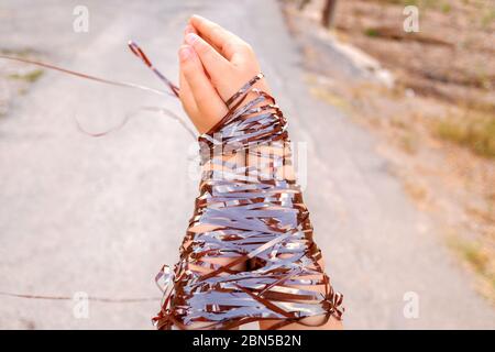 Tied hands, concept of lack of freedom and repression at different opinions. Stock Photo