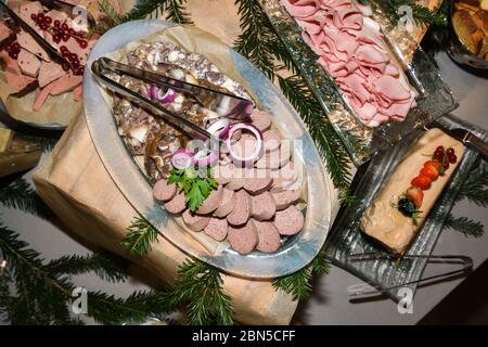 Romanian traditional Christmas food buffet with caltabos, toba and pork meat cuts, ham, platters with variety of dishes. Fresh Food Buffet Brunch Cate Stock Photo
