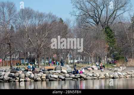 St. Paul, Minnesota.  Como Park. Family groups practice social distancing while enjoying a day in the park. Stock Photo