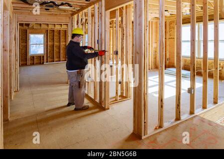 Electrical specialist checking inspects house electrical systems, electrician holding tablet PC a house under construction Stock Photo