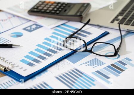 businessman work in office analysis chart graphy planning analyzing financial document data charts using calculator strategy analysis financial Stock Photo