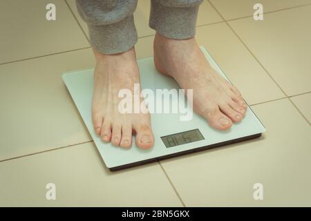 Top down view of a person standing on bathroom scales Stock Photo