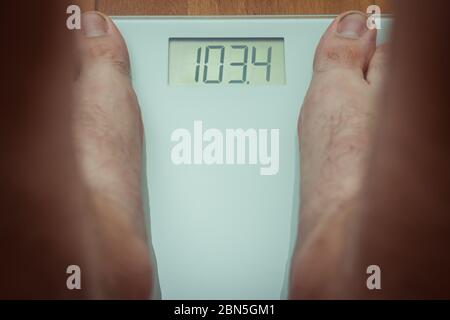 Top down view of a person standing on bathroom scales Stock Photo