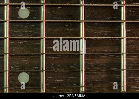 Closeup vintage guitar fretboard and the rust string is a part of the guitar. Concept of good memory About retro musical instruments and rock music. Stock Photo