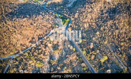 This unique photo shows the rustic autumn landscape of Hua Hin. A country road leads through this scenario. The picture is a drone photo! Stock Photo