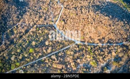 This unique photo shows the rustic autumn landscape of Hua Hin. A country road leads through this scenario. The picture is a drone photo! Stock Photo