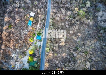 This unique photo shows the rustic autumn landscape of Hua Hin. A country road leads through this scenario. The picture is a drone photo! Stock Photo