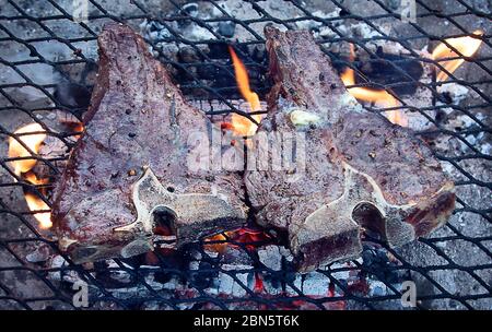 Grilling  beef steaks on flaming grill. View from above Stock Photo