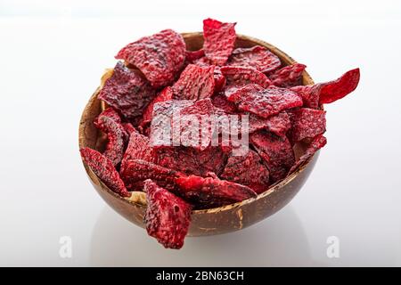 Diet healthy eating concept. Dried beet chips or baked beets in a bowl isolated on a white background. Organic natural food. Copy space. Stock Photo