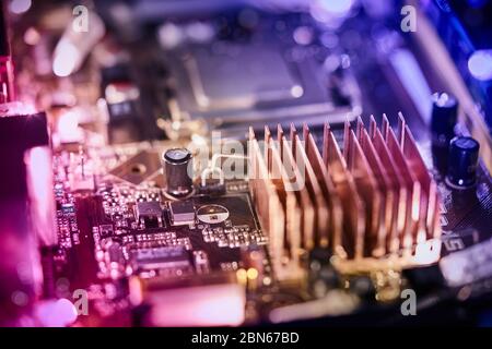 Computer motherboard background with blur neon multicolor glow, pc backdrop Stock Photo