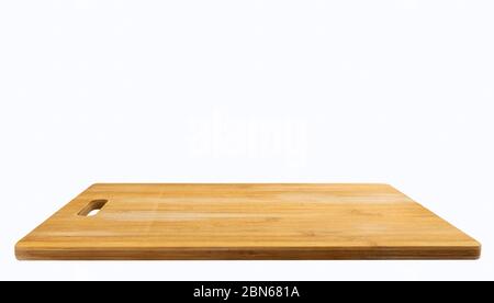 Isolated empty a bamboo wooden cutting board on white background. Brown wood cutting board. Beautiful, new and clean condition of cutting board, persp Stock Photo