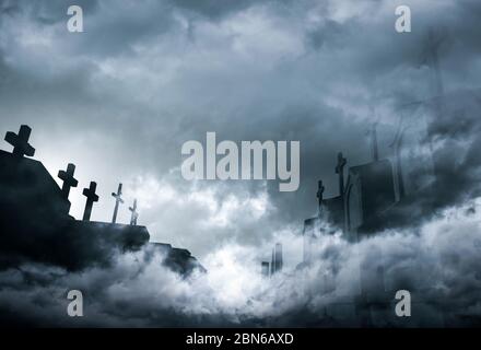 Cemetery or graveyard in the night with dark sky and white clouds. Haunted cemetery. Spooky and scary burial ground. Horror scene of graveyard. Stock Photo