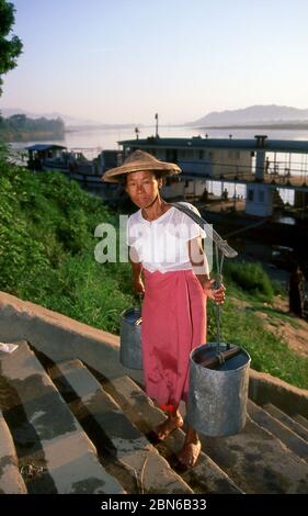 Burma / Myanmar: A woman climbs the steps near the ferry crossing close to Myitkyina's main market, Kachin State (1998).  Myitkyina is the capital cit Stock Photo