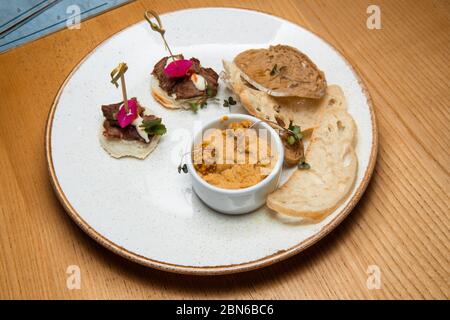 Fresh pate served with slices of crisp bread. Stock Photo