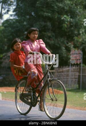 Burma / Myanmar: Lisu women on a bicycle, Manhkring, Myitkyina, Kachin State.  The Lisu people (Lìsù zú) are a Tibeto-Burman ethnic group who inhabit Stock Photo