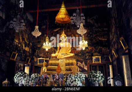 Golden Buddha statue in the hall of temple in Bangkok, Thailand Stock Photo