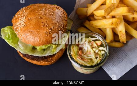 A veggie vegan burger is a burger patty that does not contain meat. These burgers may be made frm ingredinets like beans, grains, seeds or fungi such Stock Photo