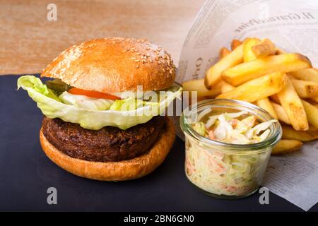 A veggie vegan burger is a burger patty that does not contain meat. These burgers may be made frm ingredinets like beans, grains, seeds or fungi such Stock Photo