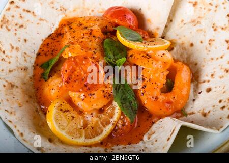 Sauteed shrimps with garlic, white wine, cherry tomatoes, fresh basil. Fresh Food Buffet Brunch Catering Dining Eating Party Sharing Concept Stock Photo