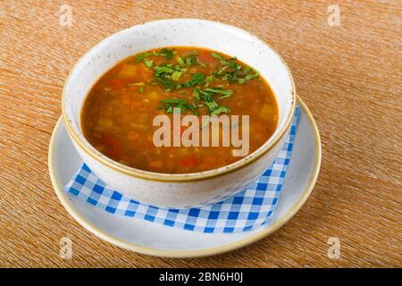 Fresh lentil soup in a white bowl, served in a restaurant setting, selective focus. Fresh Food Catering Dining Eating Party Sharing Concept, food deli Stock Photo