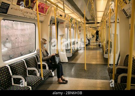 WIMBLEDON LONDON, 13 May 2020. UK.  Commuters in an  almost empty London underground train carriage  on the district line during what would normally be considered peak rush hour at 8 am. The government has announced a series of measures to slowly ease lockdown, which was introduced to fight the spread of the COVID-19 strain of coronavirus. Credit: amer ghazzal/Alamy Live News Stock Photo