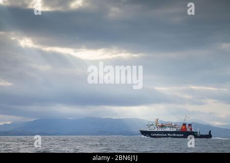 A small Caledonian MacBrayne ferry arriving leaving Loch Scresort on the Isle of Rum and heading back to  Mallaig on the west coast of Scotland Stock Photo